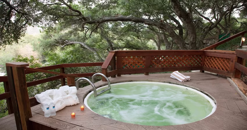 Sycamore Mineral Springs Resort & Spa Sycamore Mineral Springs Resort & Spa private patio mineral tub surrounded by lush Central Coast scenery.